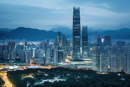 城市夜景背景图片_一个有很多高楼大厦和背景山脉的城市