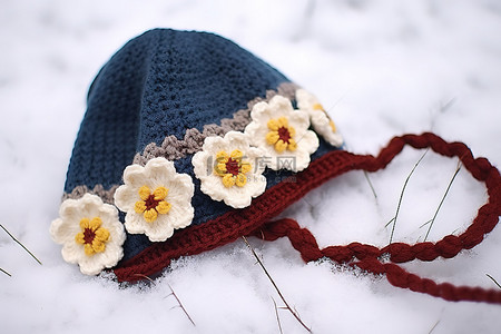 围巾背景图片_蓝色围巾上有小黄花的雪帽子