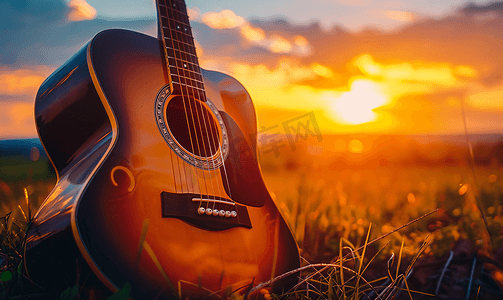 吉他手图片摄影照片_夕阳下的吉他特写