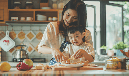 灶台摄影照片_亚洲人年轻妈妈和儿子在厨房