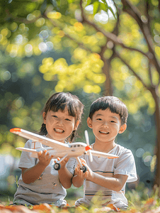 亚洲人拿着玩具飞机在公园玩耍的快乐儿童