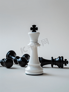 散落的桃心摄影照片_胜利的概念白色的棋子站着黑色的棋子散落在周围