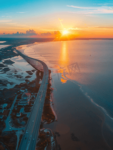 禧摄影照片_阿拉巴马湾沿岸日落时莫比尔湾和朱比利公园大道桥的鸟瞰图