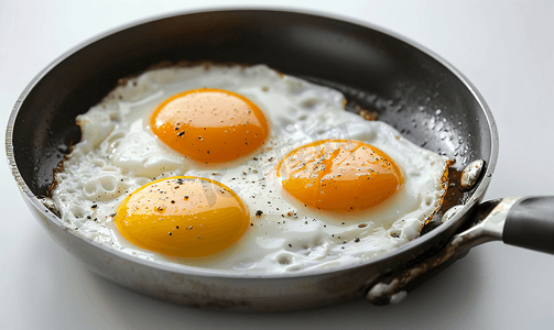 炸油摄影照片_热油锅中煎两个鸡蛋