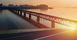 城市跨江大桥夕阳路面夕阳大桥路面大桥城市摄影图配图