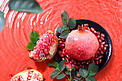 水果棚拍新鲜石榴红色背景水波纹摄影图配图
