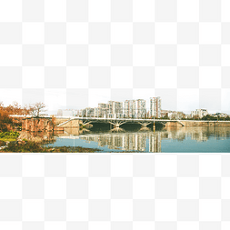 城市建筑图片_河提边的公园河旁的城市