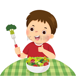 一个小男孩吃新鲜蔬菜沙拉并展示