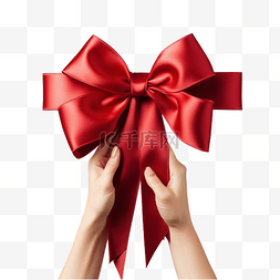 礼物盒系带图片_女手从角度在红色圣诞礼物上系上