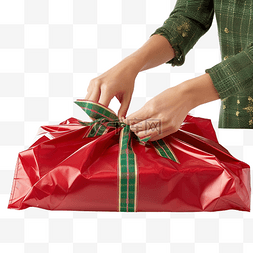 准备圣诞节时将礼物放入袋子的特