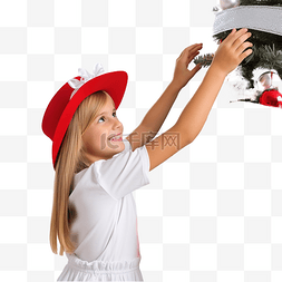人在装饰圣诞树图片_一个戴着圣诞老人帽子的女孩在家