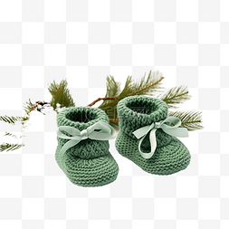 明亮图片_圣诞节新生儿的绿色靴子，配有蜡
