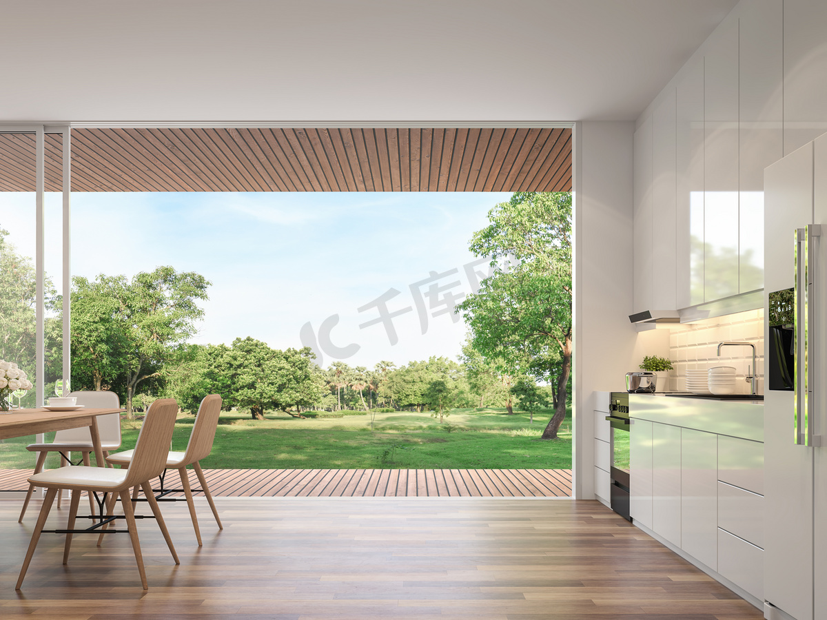 现代用餐室3D渲染。客房铺有木地板，装饰有木制家具，配有带大开门的光泽白色厨房柜台。俯瞰露台和大花园.图片