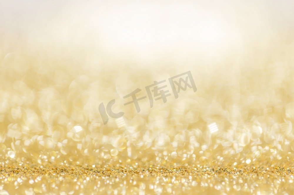 闪亮的金光bokeh背景圣诞节新年庆祝豪华聚会。闪亮的金色灯光背景图片