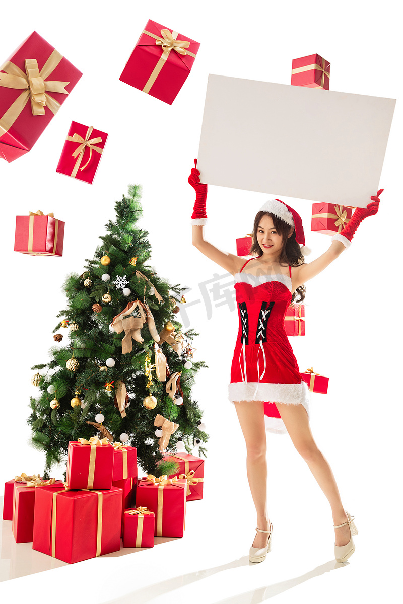 过圣诞节的年轻女人拿着白板图片