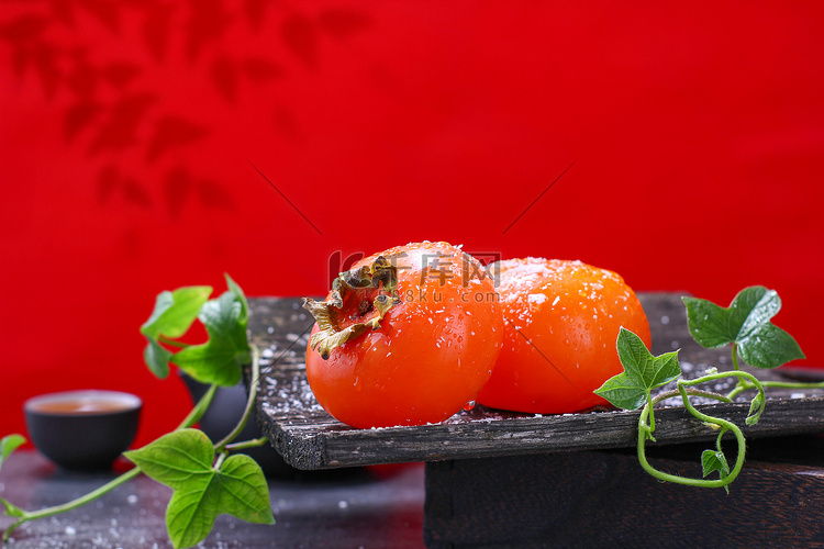 水果秋收柿子红柿子红色背景摄影