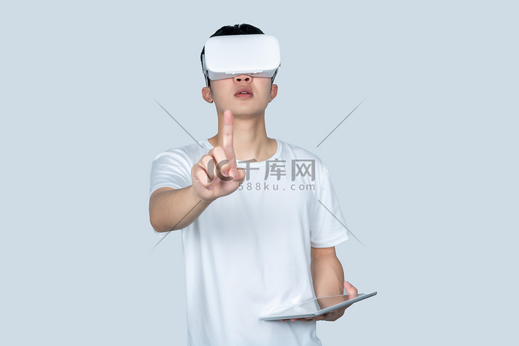 年轻男性VR眼镜手拿平板点击