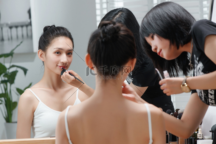 化妆师给青年女人化妆