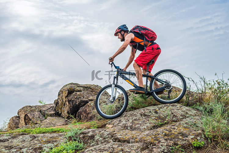 骑自行车的人顺着山上的石头往下