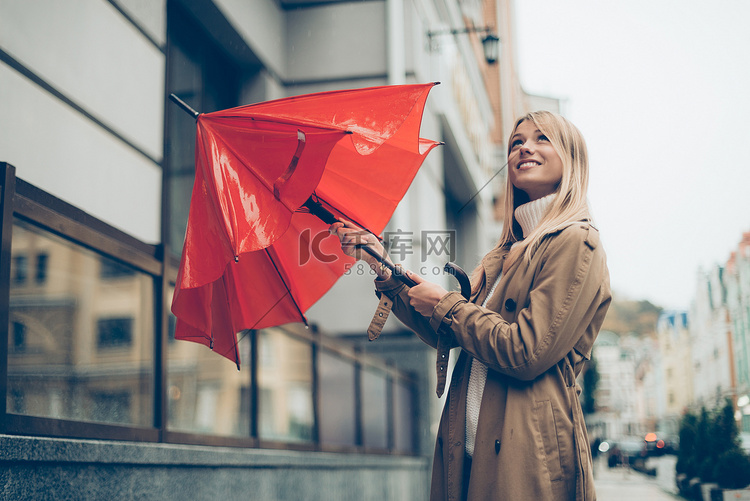 带着雨伞的年轻漂亮女人