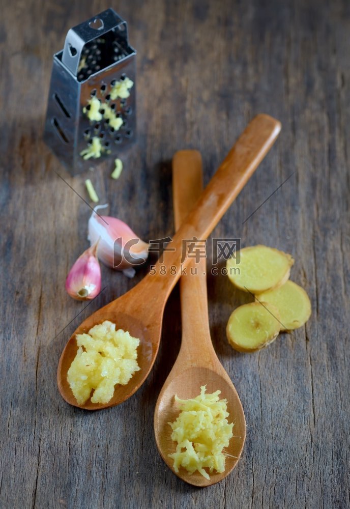 大蒜和生姜在木勺上木桌