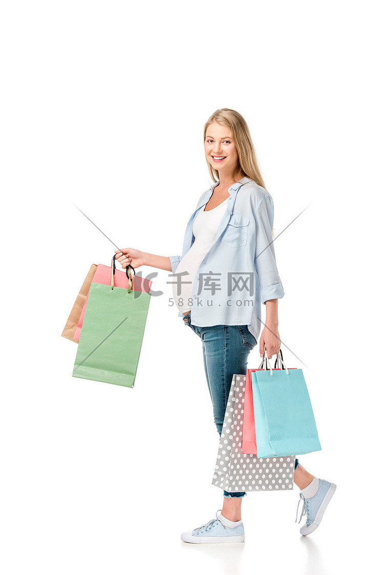 购物袋白色上孤立的幸福怀孕女人