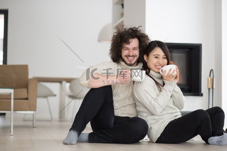 年轻浪漫的多民族情侣坐在家里壁