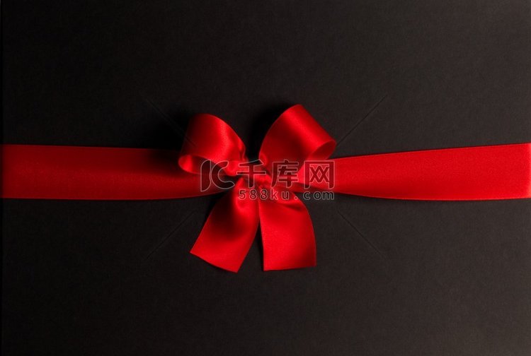 黑色背景上的红色礼物蝴蝶结。黑