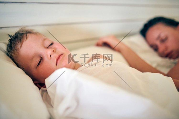 三岁的蹒跚学步的男孩睡在枕头上