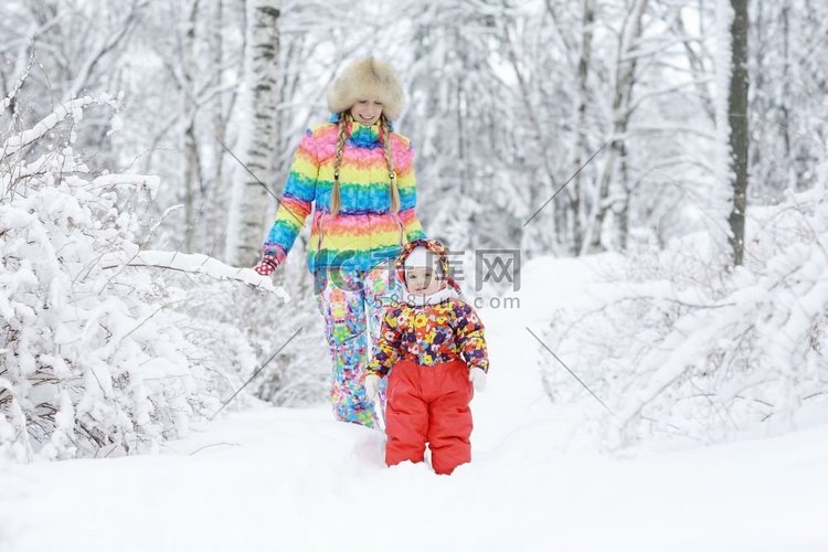 在雪地上的冬天散步的快乐的小女