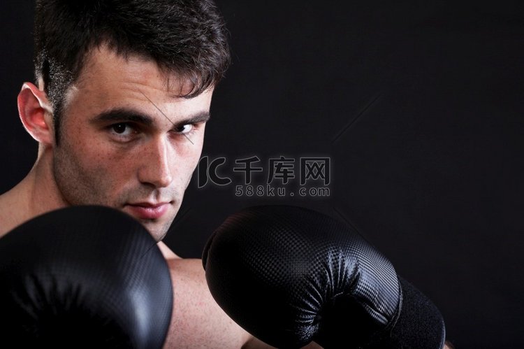 肖像运动员拳击手在工作室反对黑