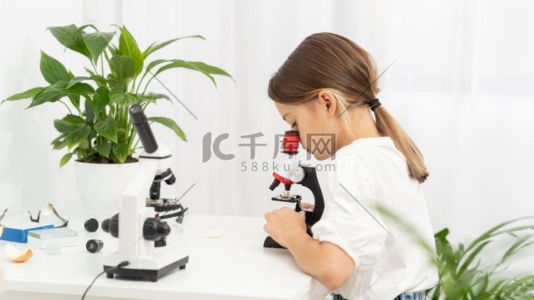 侧面观察显微镜下的年轻女孩