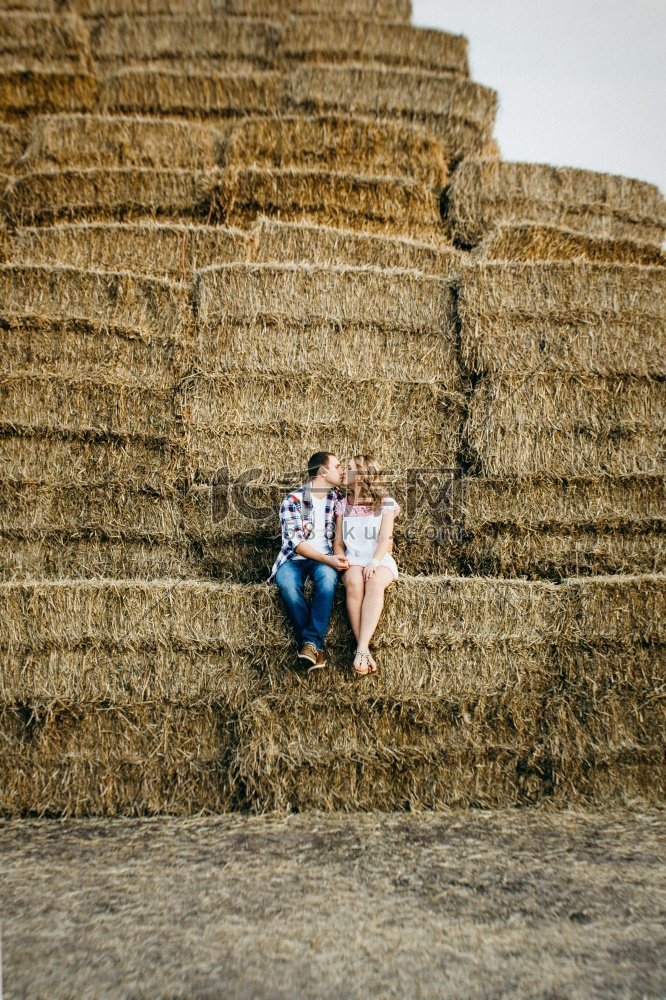 一个男人和一个女孩在圆圆的干草
