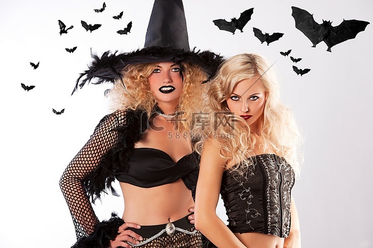 两个年轻漂亮的女孩穿着巫婆黑色