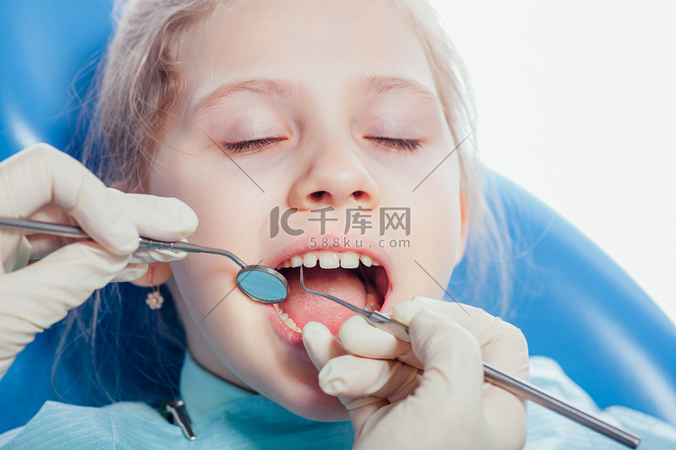 Little girl sitting in the dentists office