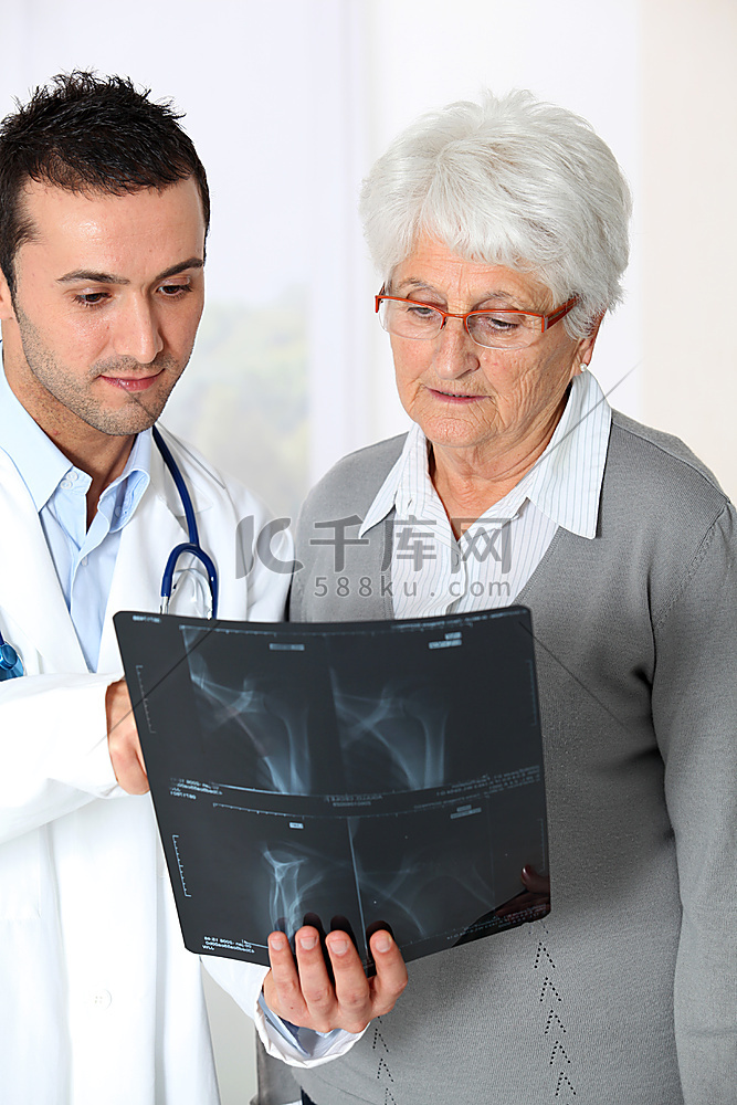 医生向老年妇女展示X光结果