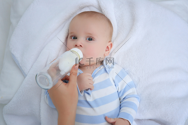 Mother feeding baby from bottle