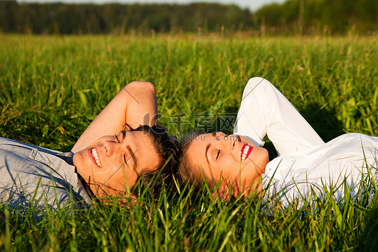 夏天，一对年轻的夫妇一起躺在绿