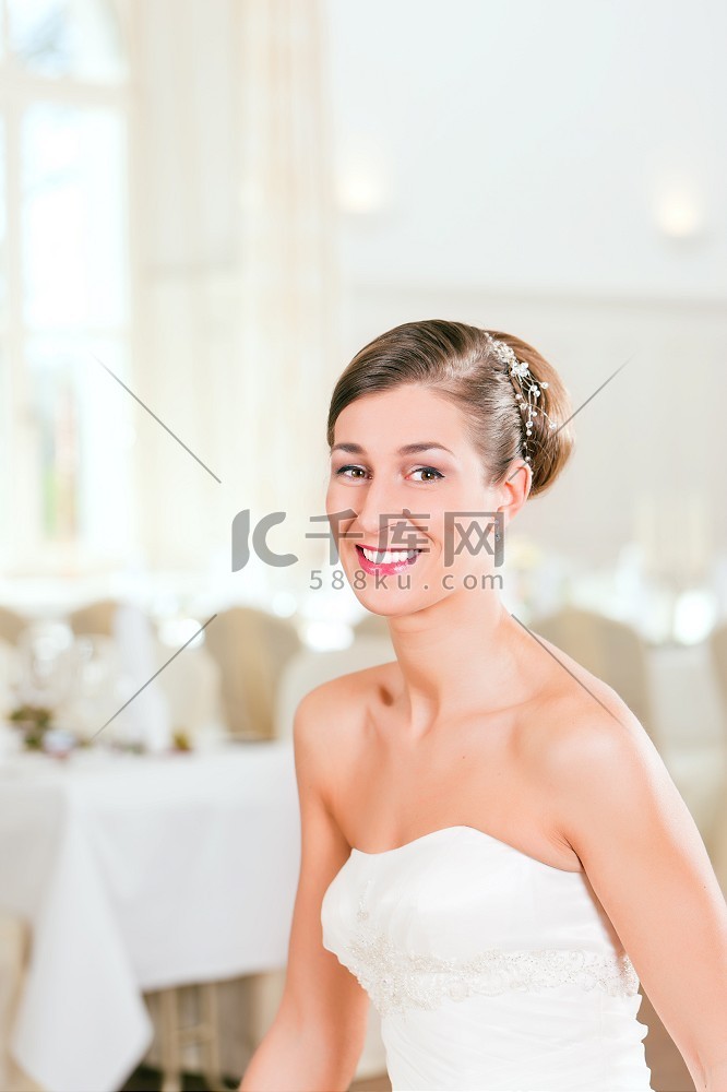 微笑的新娘在婚礼前梳着向后梳的