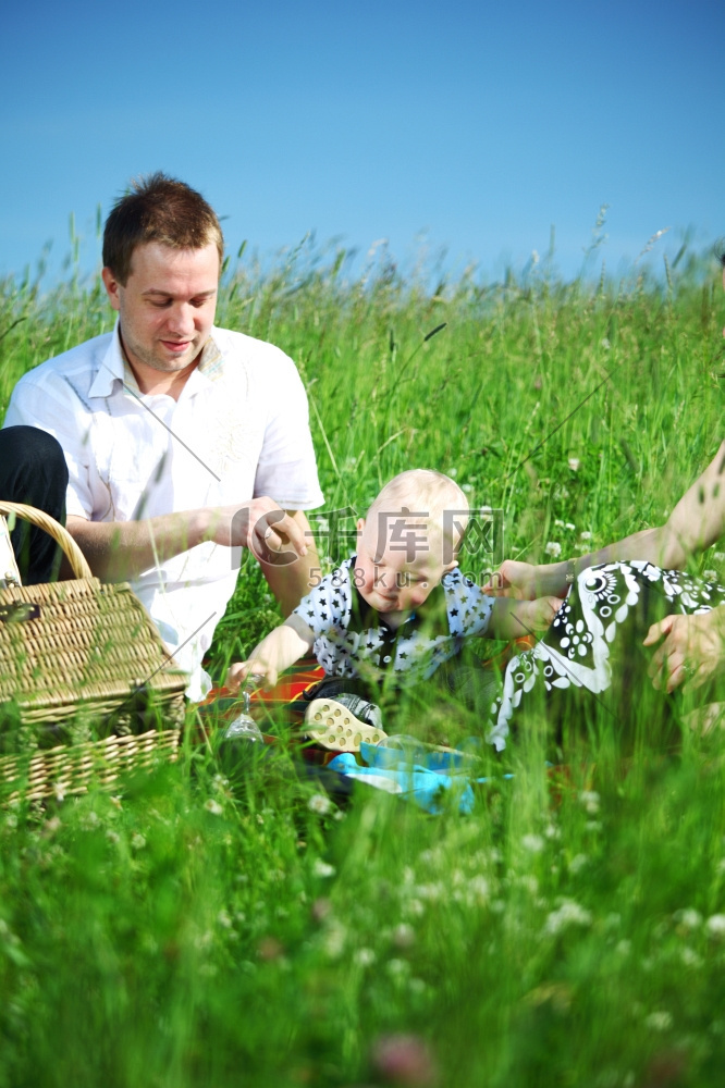 幸福的一家人在绿草如茵的野餐