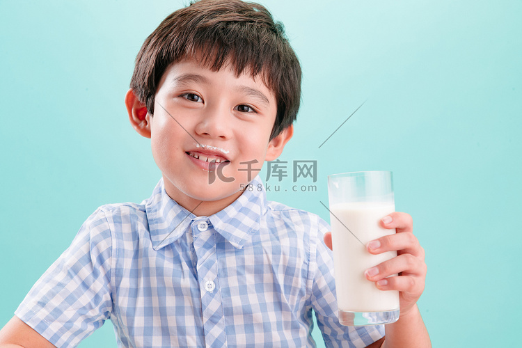 小男孩拿着一杯牛奶