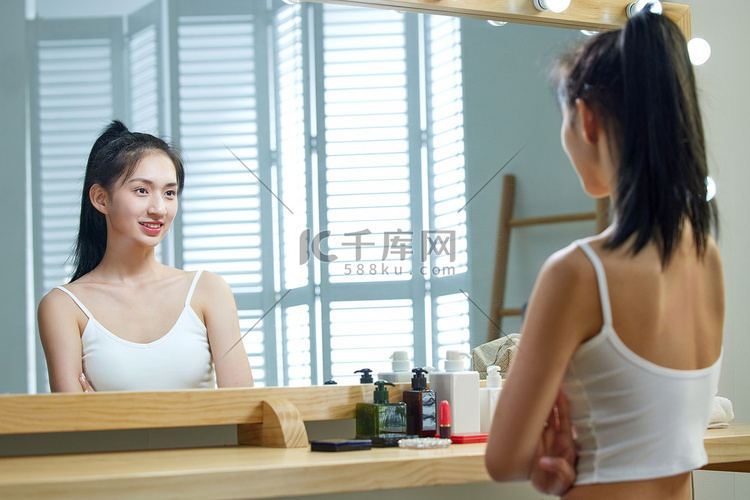 漂亮的年轻女人照镜子