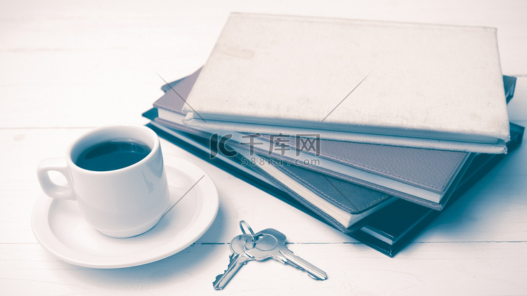 咖啡杯、钥匙和一摞书的复古风格