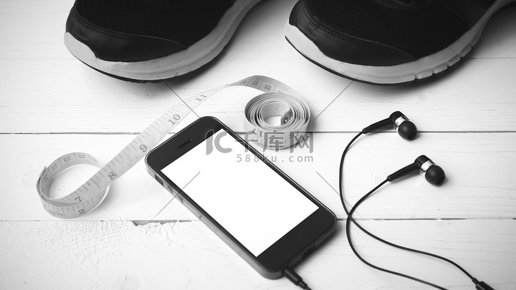 跑步鞋、卷尺和手机黑白色调