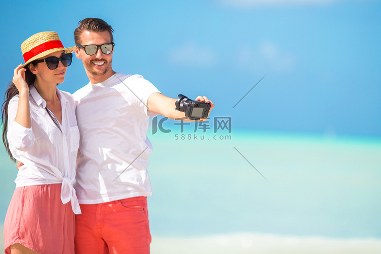 蜜月假期在白色沙滩上拍照的幸福