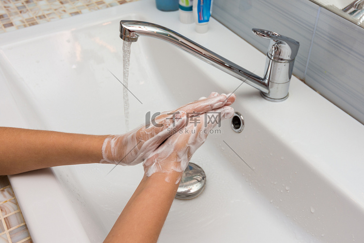 孩子用肥皂水仔细地洗手