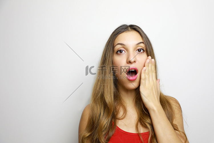 红唇惊讶的女人用手托着脸颊。