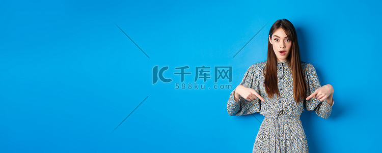 穿着裙子的兴奋的年轻女性用手指