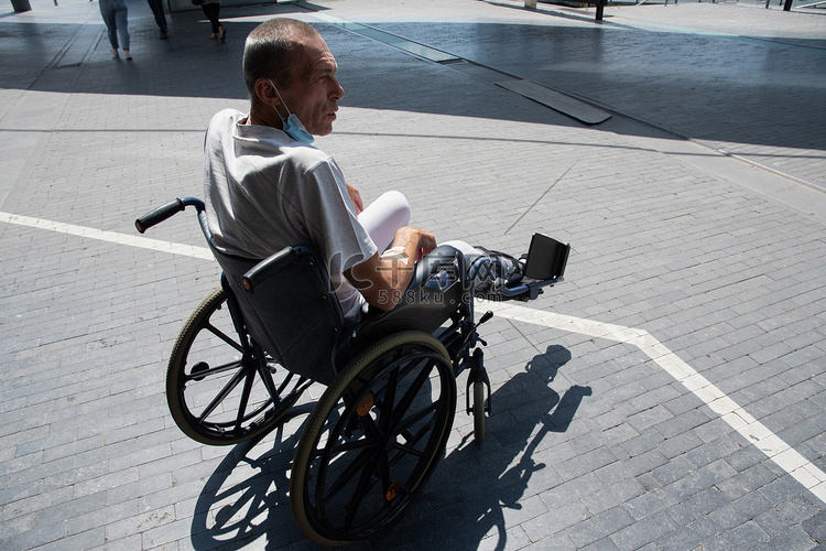 腿断了打石膏的中年男子坐在轮椅