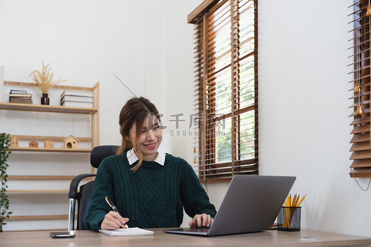 亚洲女学生在家远程学习，使用笔